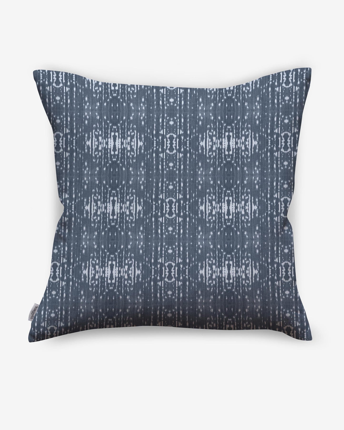 A pillow with a blue and white Indigo Ikat pattern