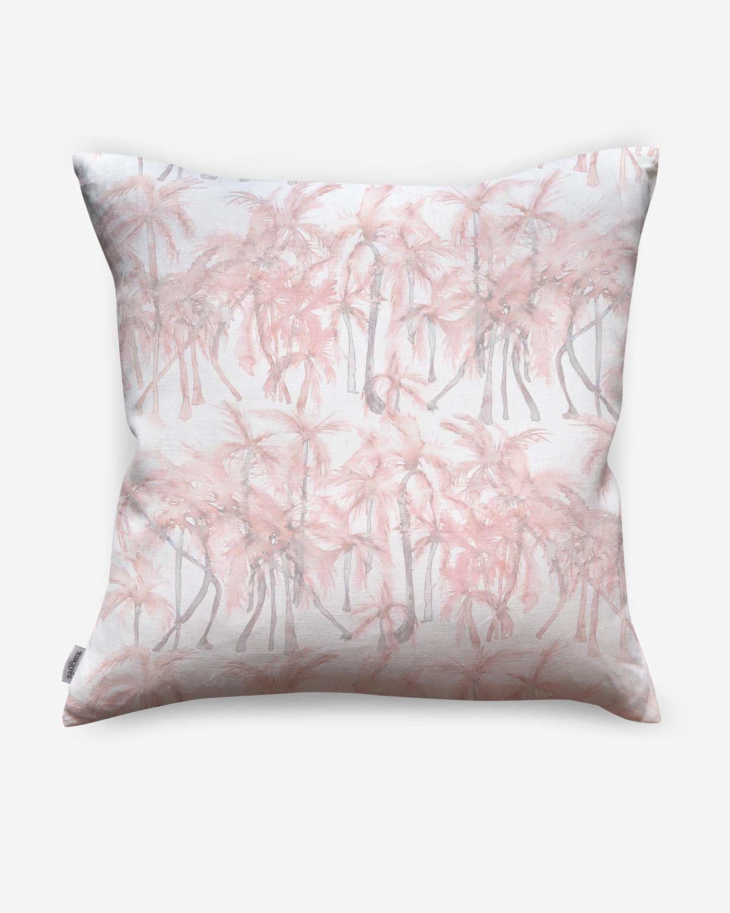A pink and white Palm Dance Pillow Coral with palm trees on it that features a watercolor pattern