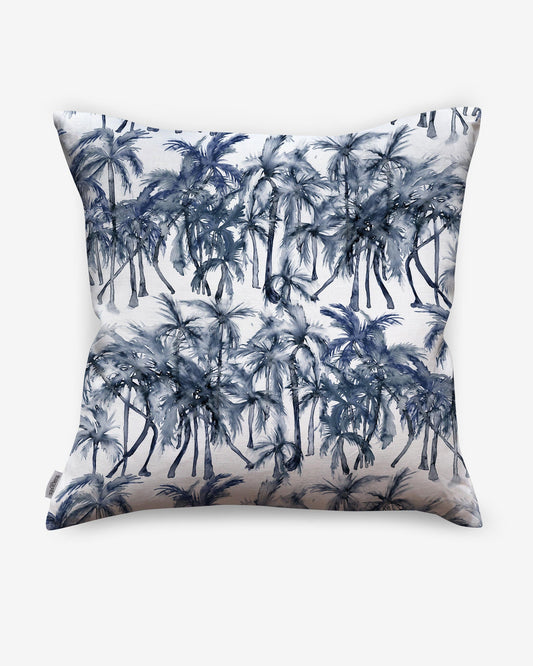 A blue and white Palm Dance Pillow Midnight with palm trees on it made of luxury fabric
