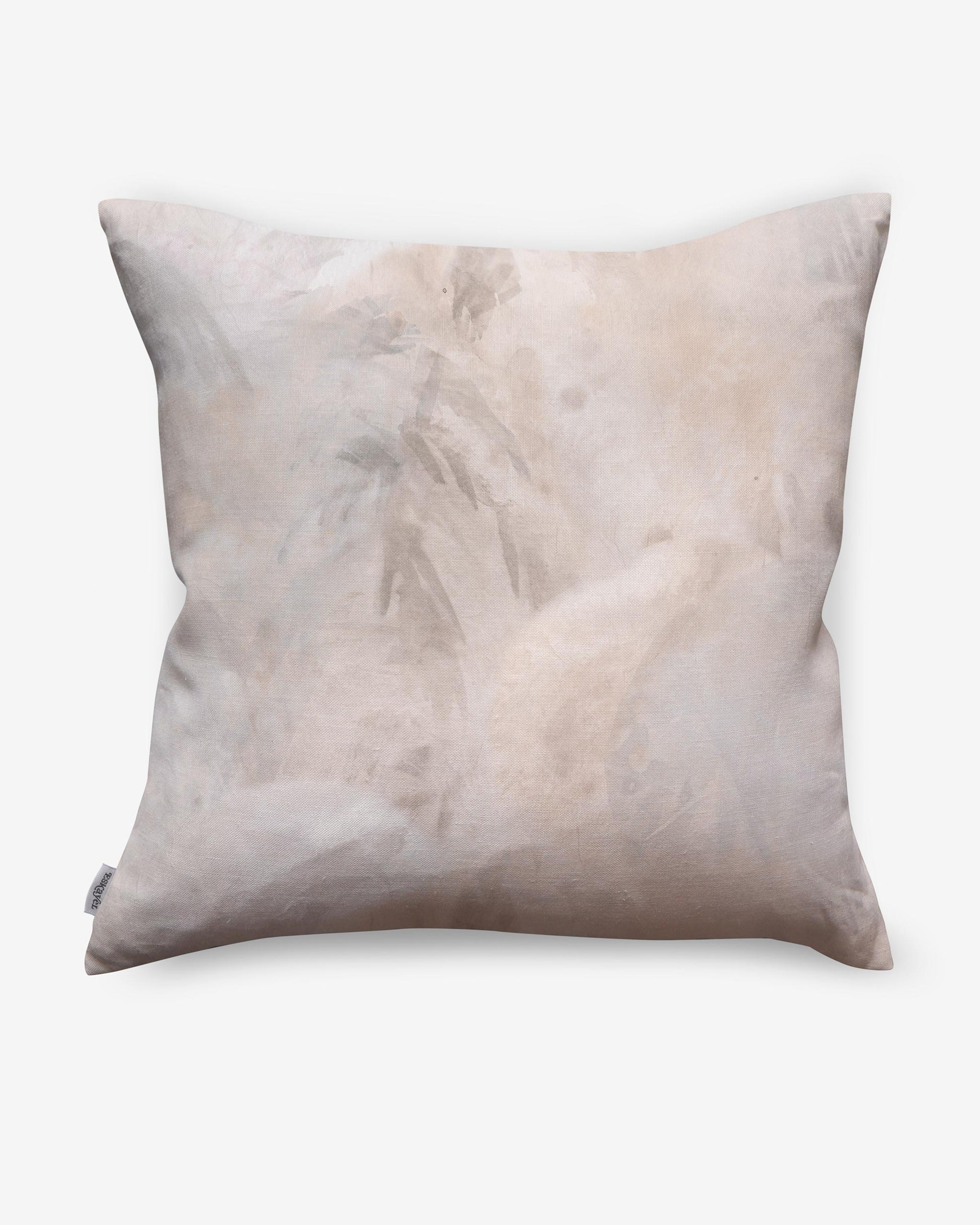 A Palmeti Pillow Luminosa with a white and peachy pink fabric pattern on it
