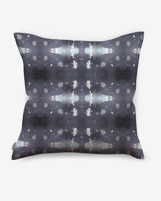 A Polaris Pillow with a grey and white pattern on it