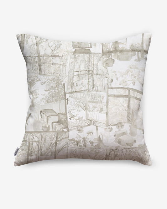 A high-end Quotidiana Pillow||Sand with verdant views of a house and trees.