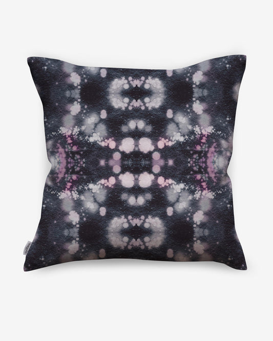 A black and pink Solar Pillow Nila with a celestial tie dye pattern