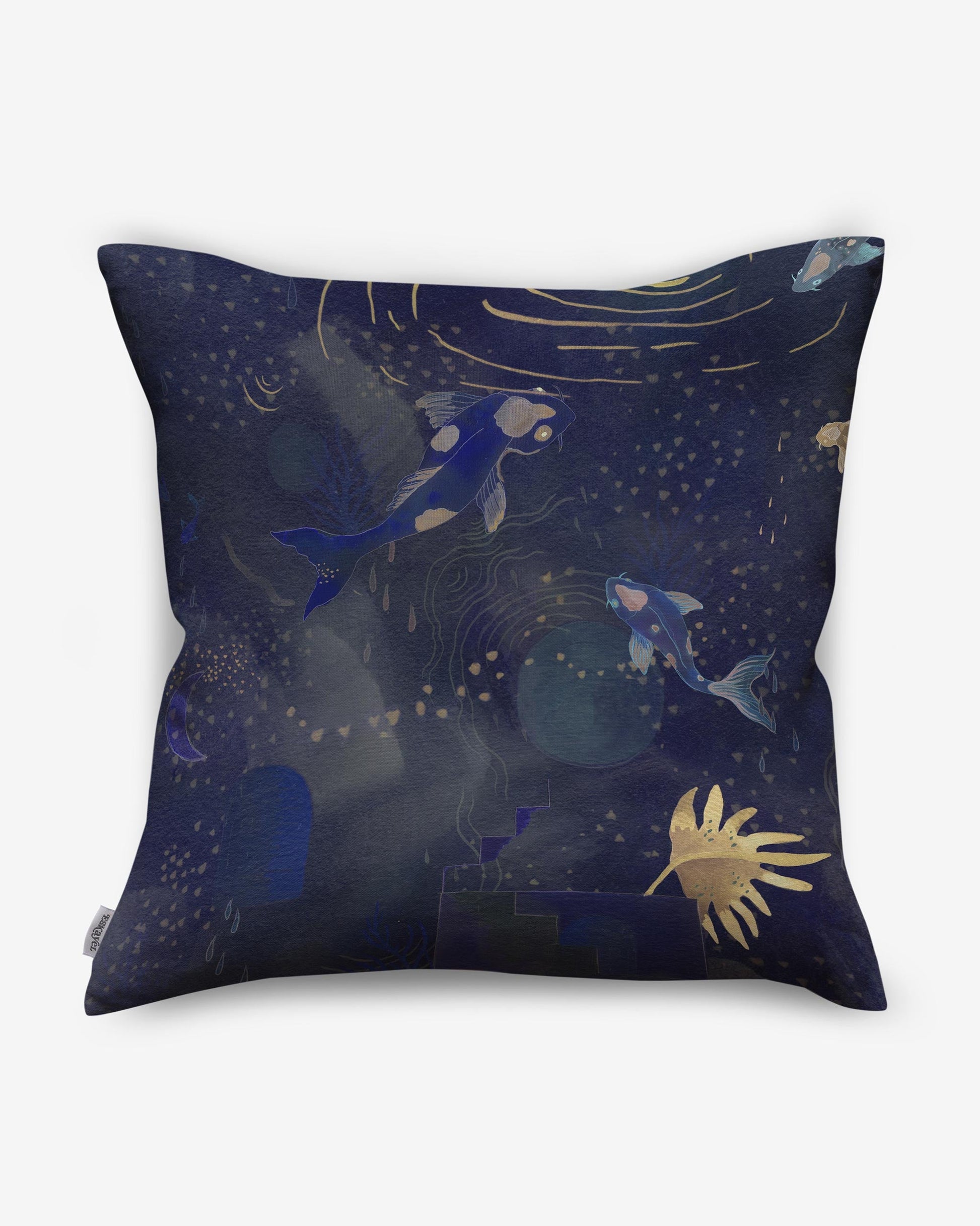 A high-end Water Signs fabric pillow with an indigo background adorned with fish and stars