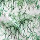 A green and white fabric with palm trees, a watercolor pattern and Palm Dance Performance Fabric Chloros