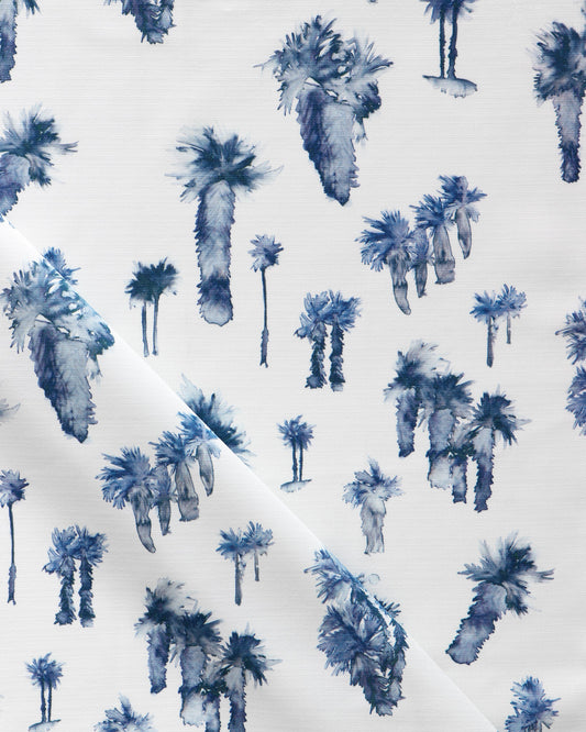 A luxurious Perfect Palm Performance Fabric Midnight in a blue and white color scheme depicting palm trees on it