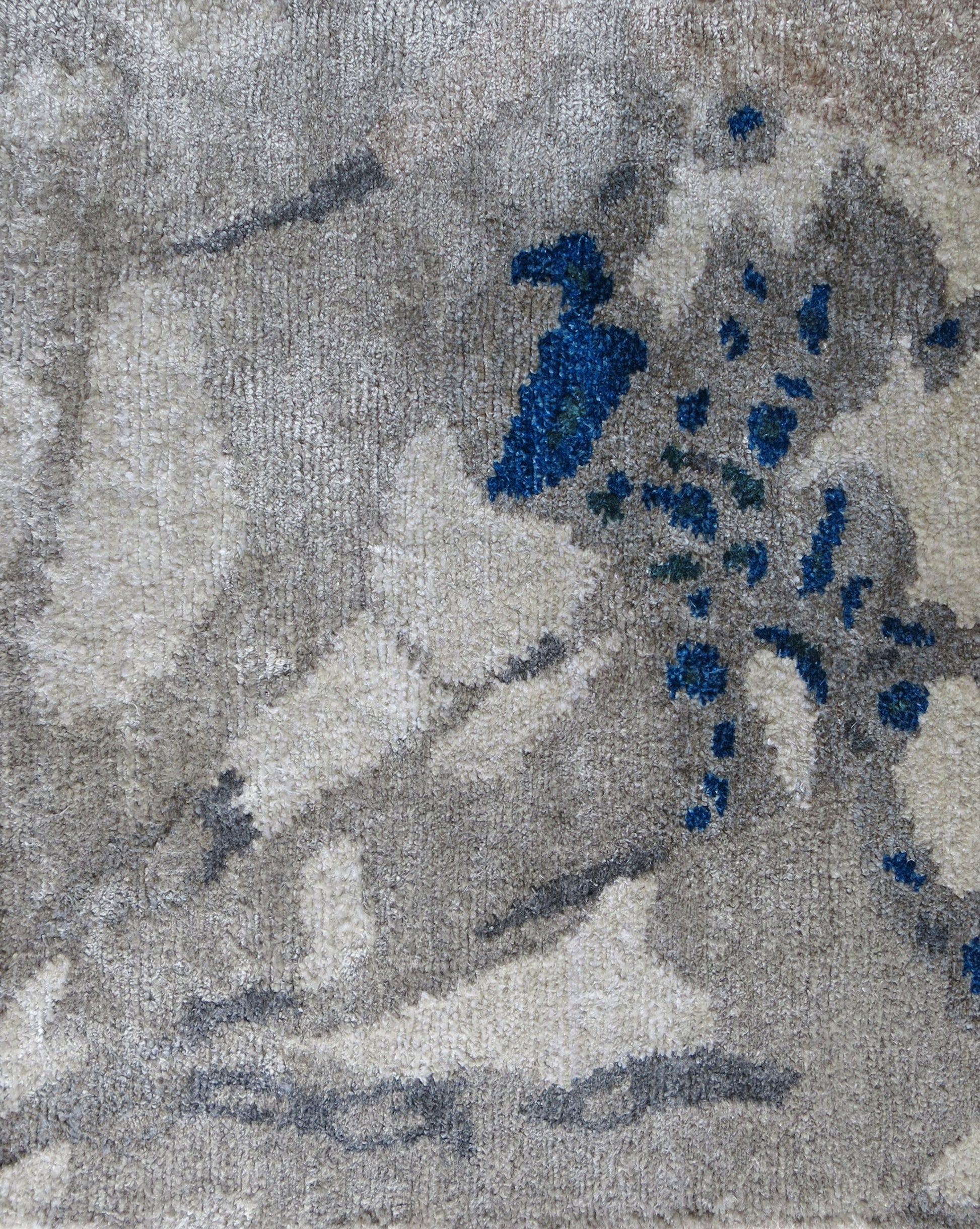 A custom handmade Cabrillo Hand Knotted Rug  Stone from the Presidio Collection, featuring blue flowers on a grey and blue background