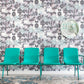 A row of green chairs in front of a Cabrillo Hand Knotted Rug  Stone wallpapered wall