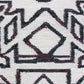 A close up of the Akimbo 5 Flatweave Rug Black And White with a geometric design