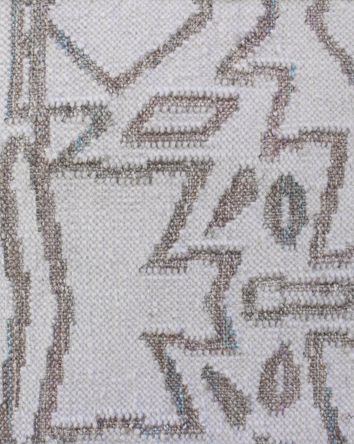 A close up of the Akimbo Flatweave Rug with a geometric pattern
