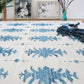 An Areca Palms Flatweave Rug with blue and white designs on it is available in the midnight colorway