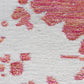 A close up of a durable Nairutya Flatweave Rug Raspberry from the Jangala Collection with pink and white splatters