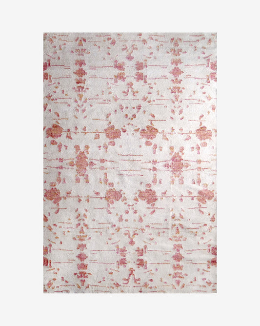 A pink and white floral rug from the Jangala Collection, featuring the Nairutya Flatweave Rug||Raspberry pattern, on a white background.