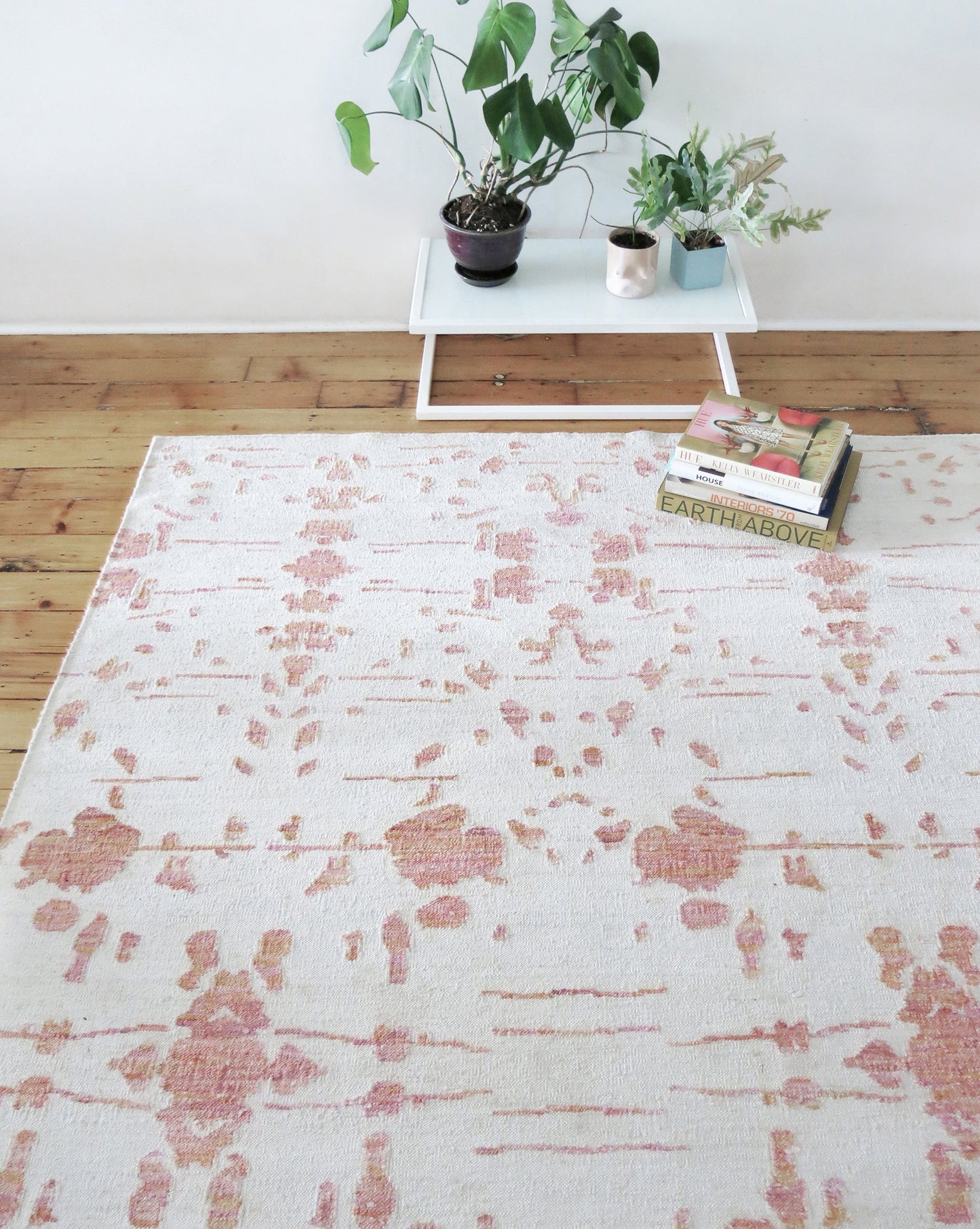 A pink and white Nairutya Flatweave Rug Raspberry from the Jangala Collection, with a durable flatweave construction, featuring the Nairutya pattern