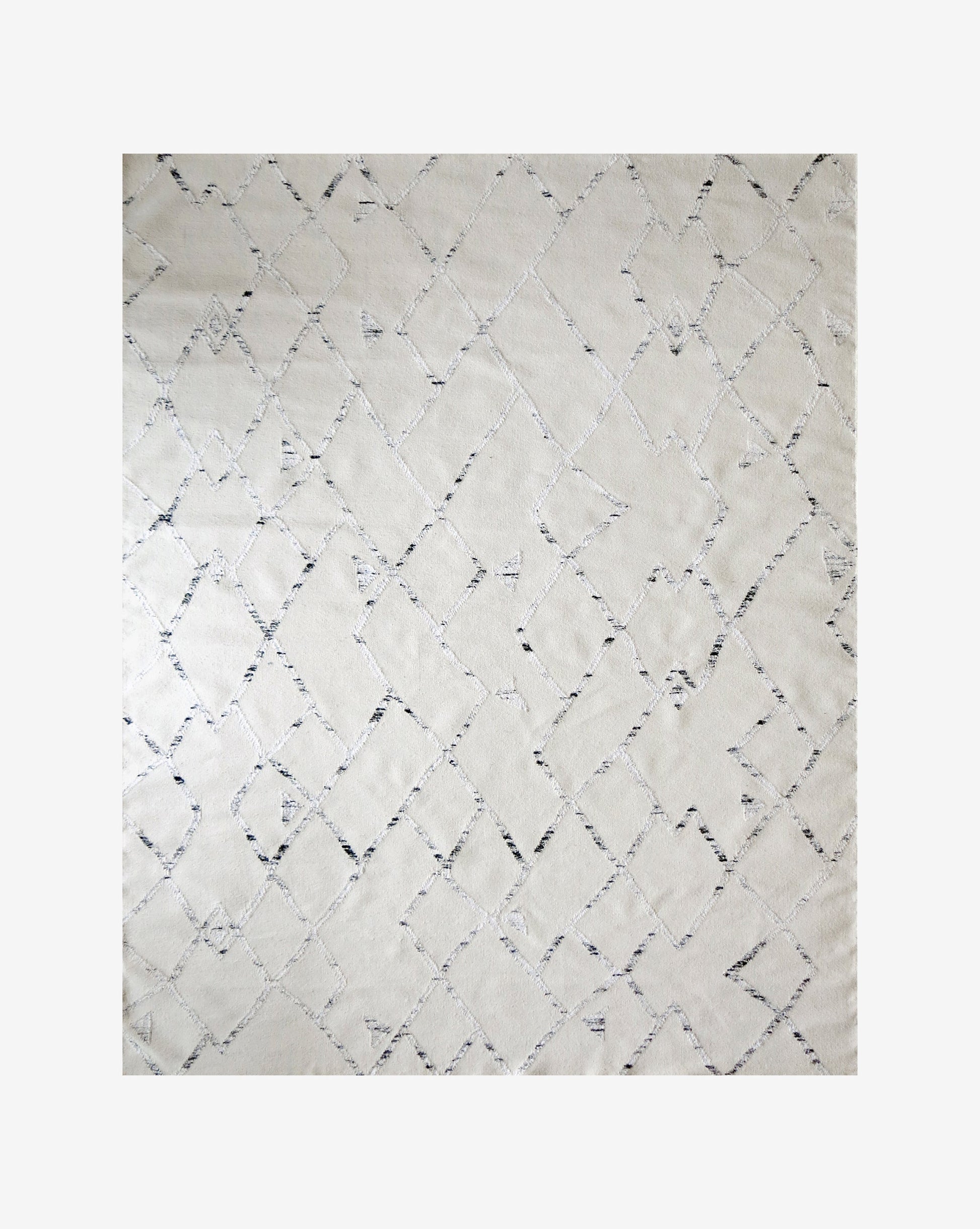 A white and black Peaks Flatweave Rug Snow with a diamond pattern