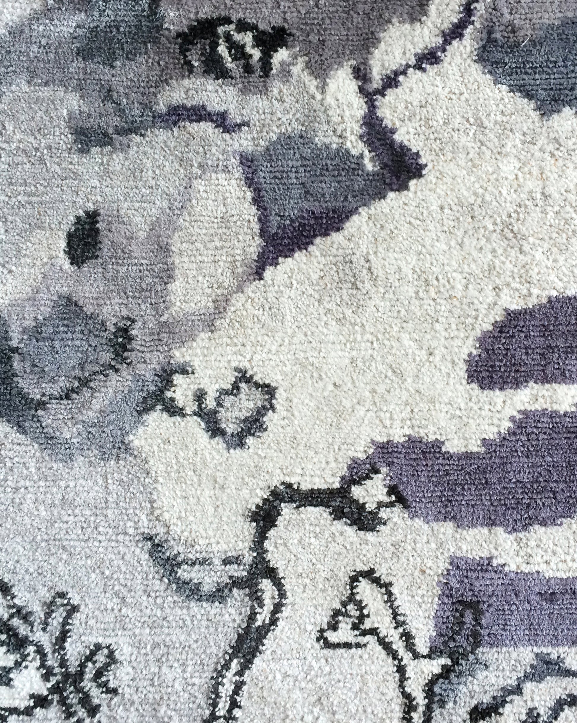 A close up of a handmade Bosky Toile Hand Knotted Rug Midnight