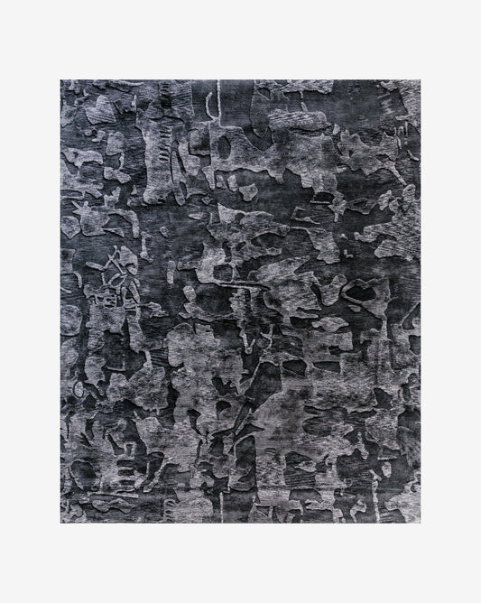 A black and gray Kotoubia Hand Knotted Rug||Stardust on a white background.