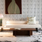 A couch in a living room with a painting on the wall and a Linea Hand Knotted Rug Black And Beige
