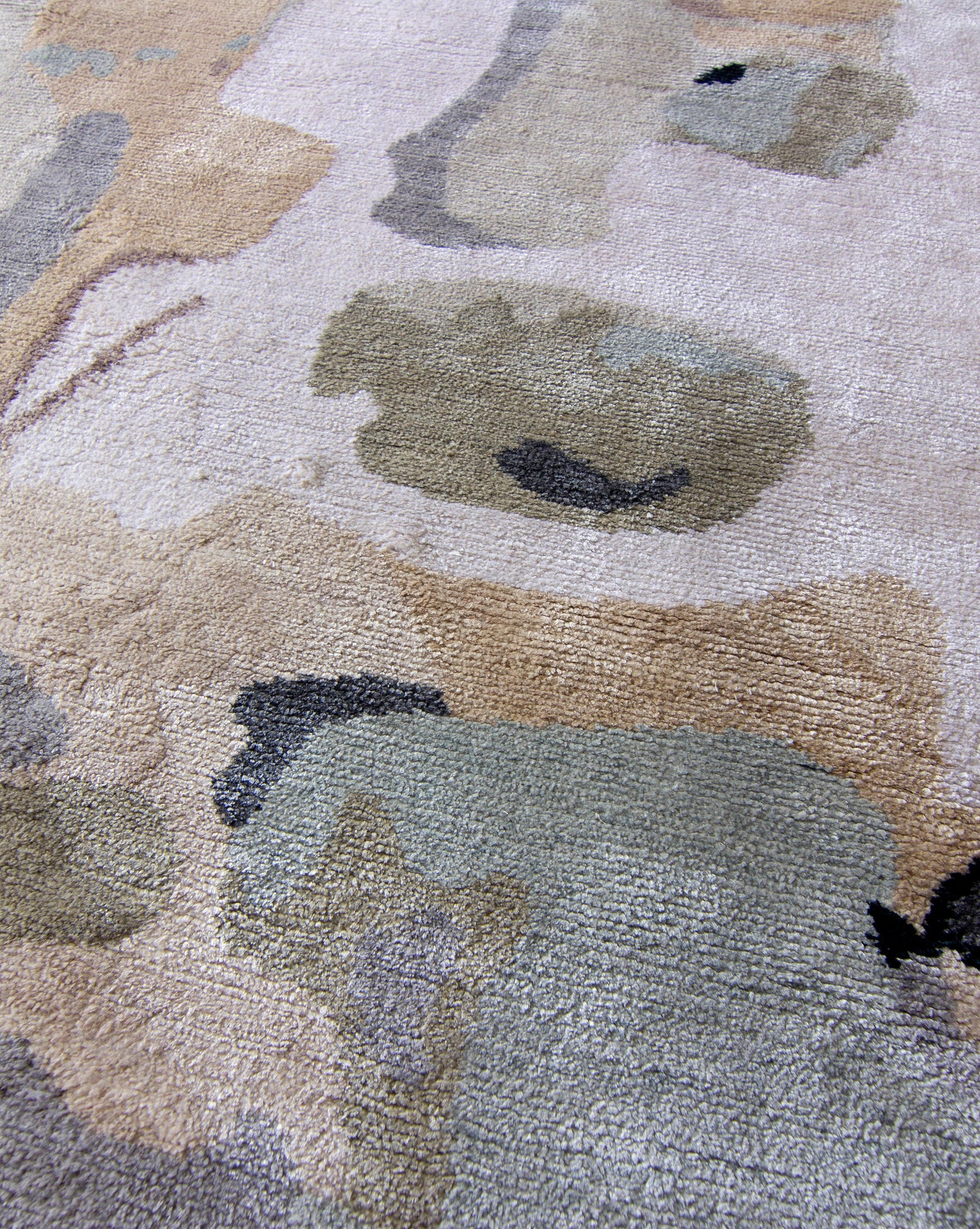 A close up of a Medina Hand Knotted Rug with abstract designs on it.