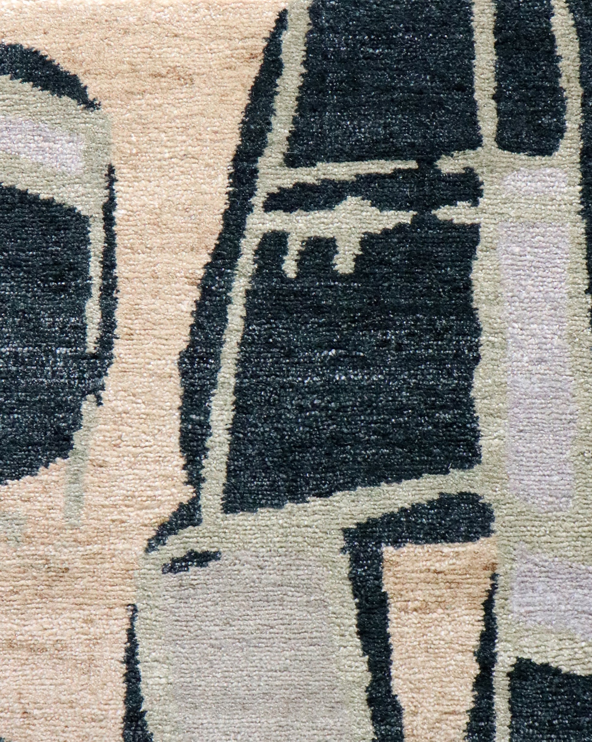 A Quotidiana Hand Knotted Rug Corinth with a black and beige design on it
