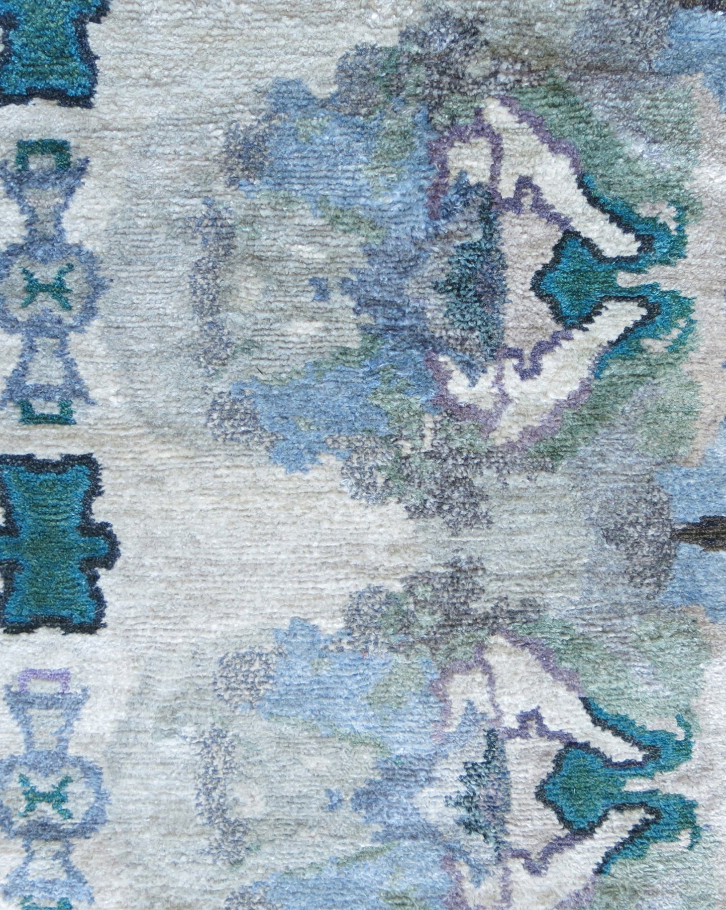 A Septaria Hand Knotted Rug Light featuring a vibrant blend of blue, green, and purple colors