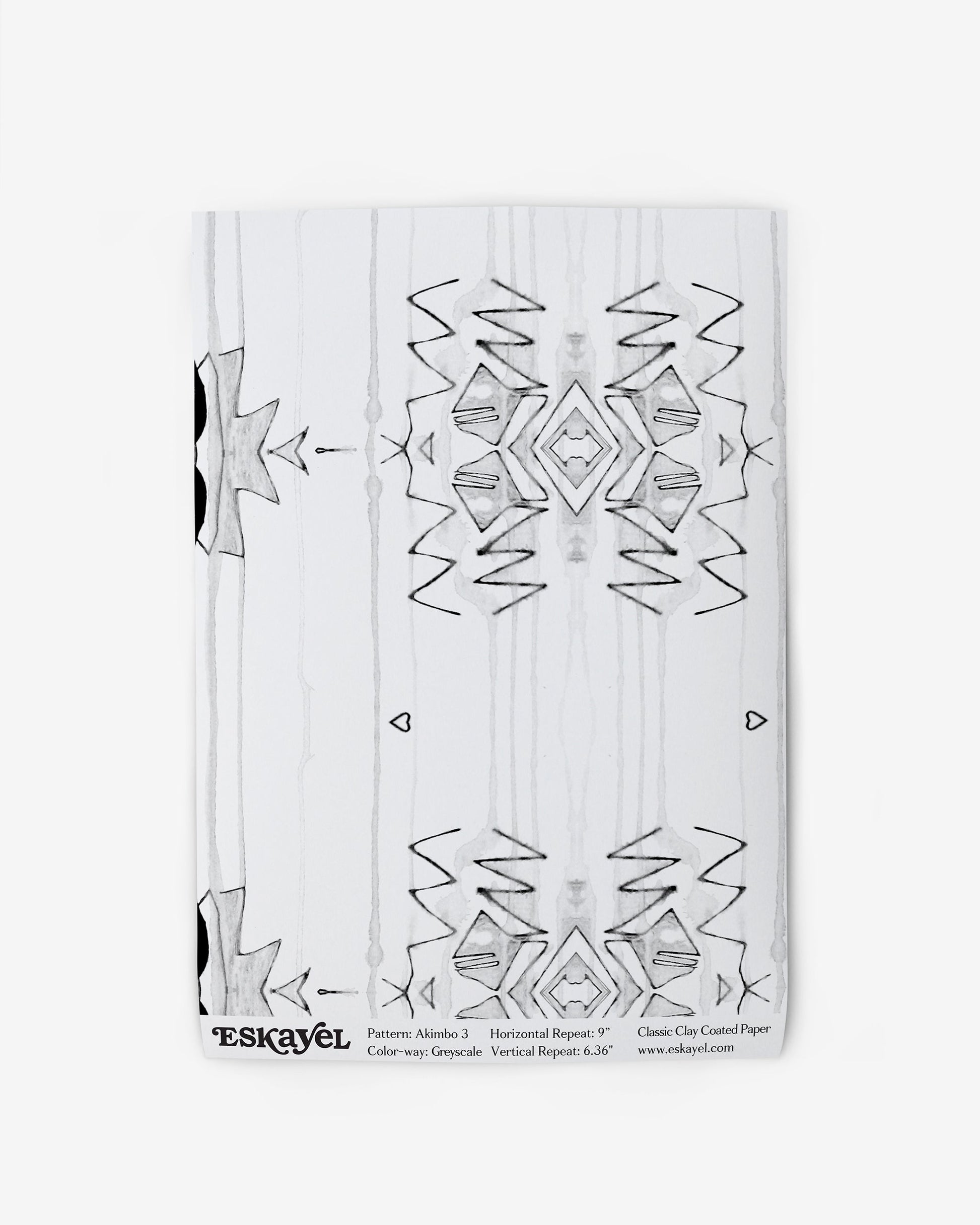 A notebook with an Akimbo 3 Wallpaper Greyscale design on it