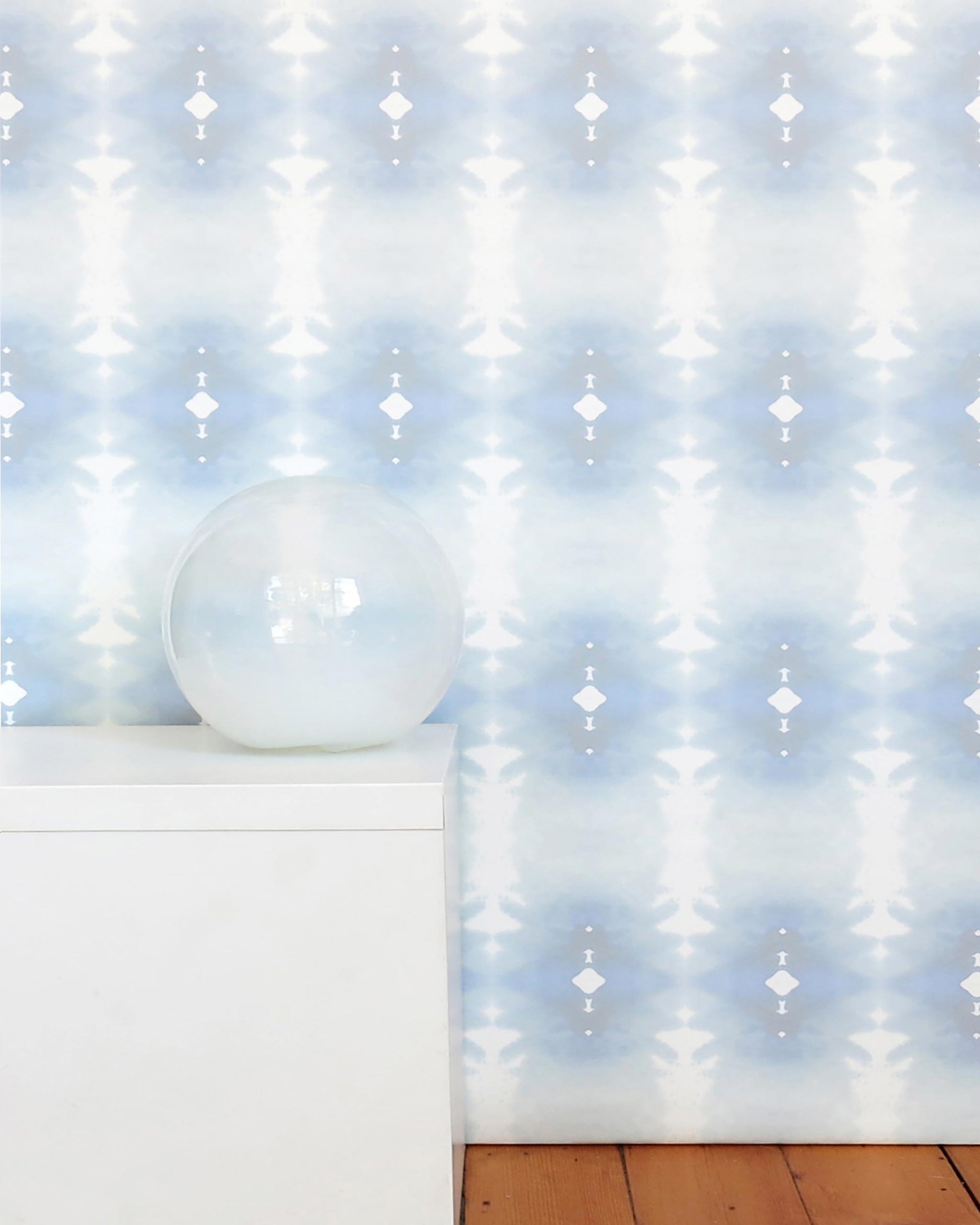 A blue and white Areca Palms Wallpaper Mist with a vase in front of it