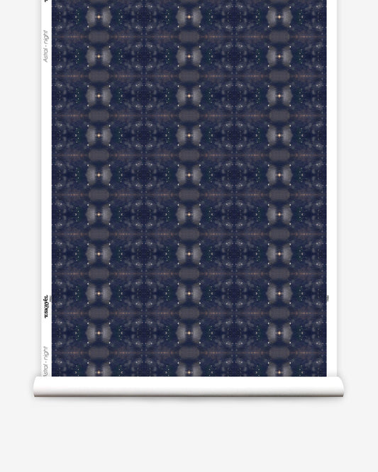 A roll of Astral Wallpaper||Night from the Jangala Collection with a dark blue pattern on it.