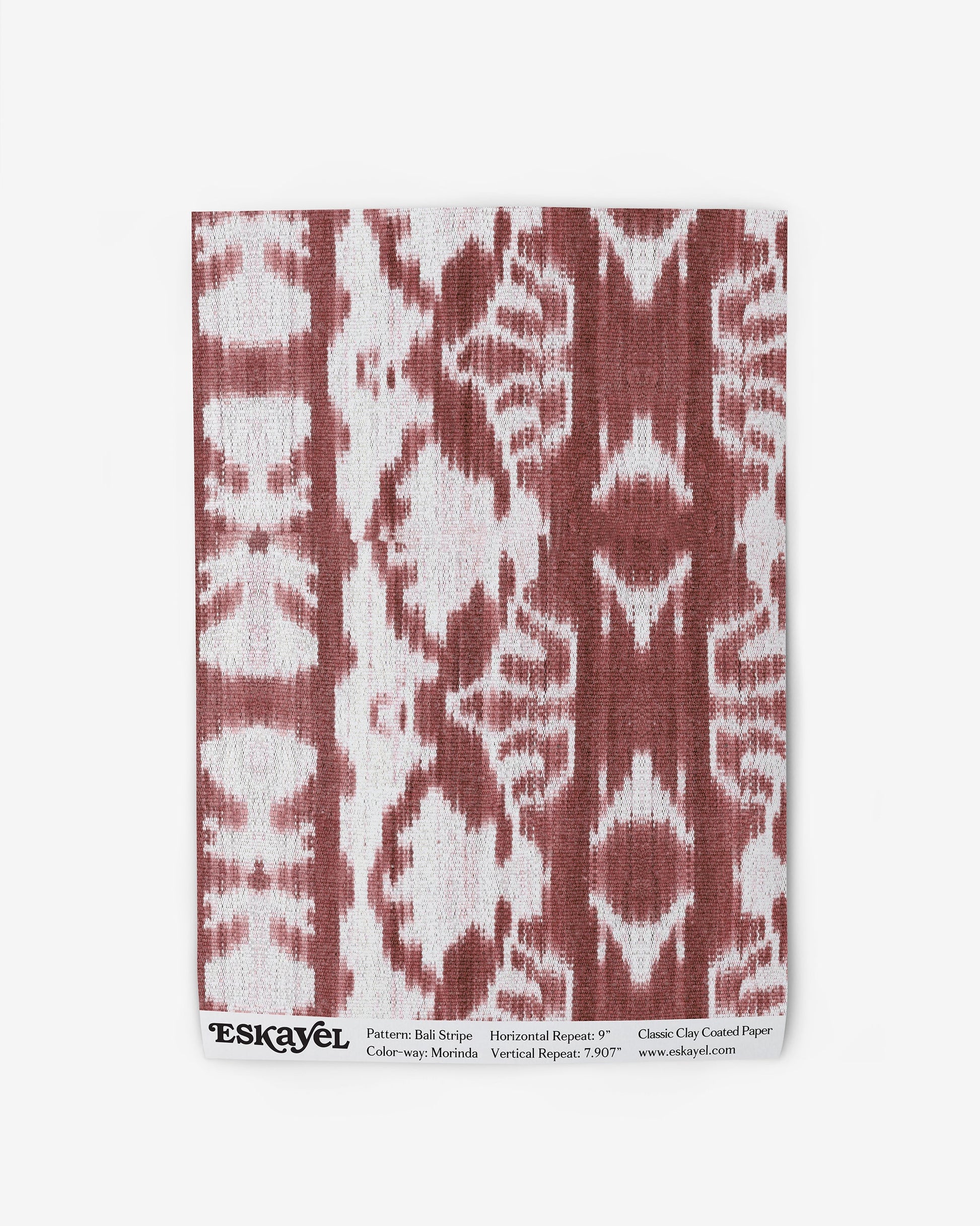 A red and white linen wallpaper with a Bali Stripe Wallpaper Morinda Ikat