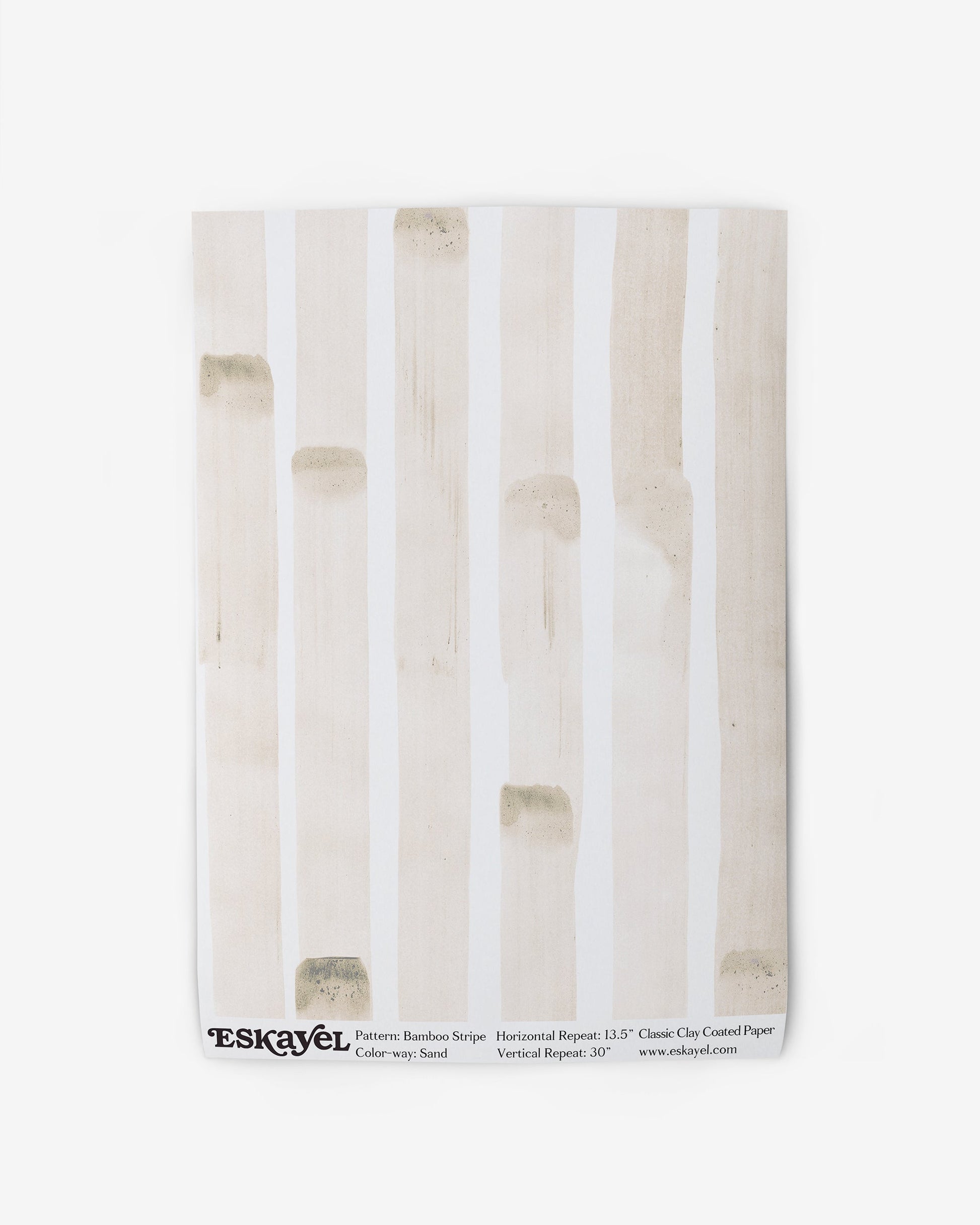 A white towel with a beige stripe from the Bamboo Stripe Wallpaper||Sand range.