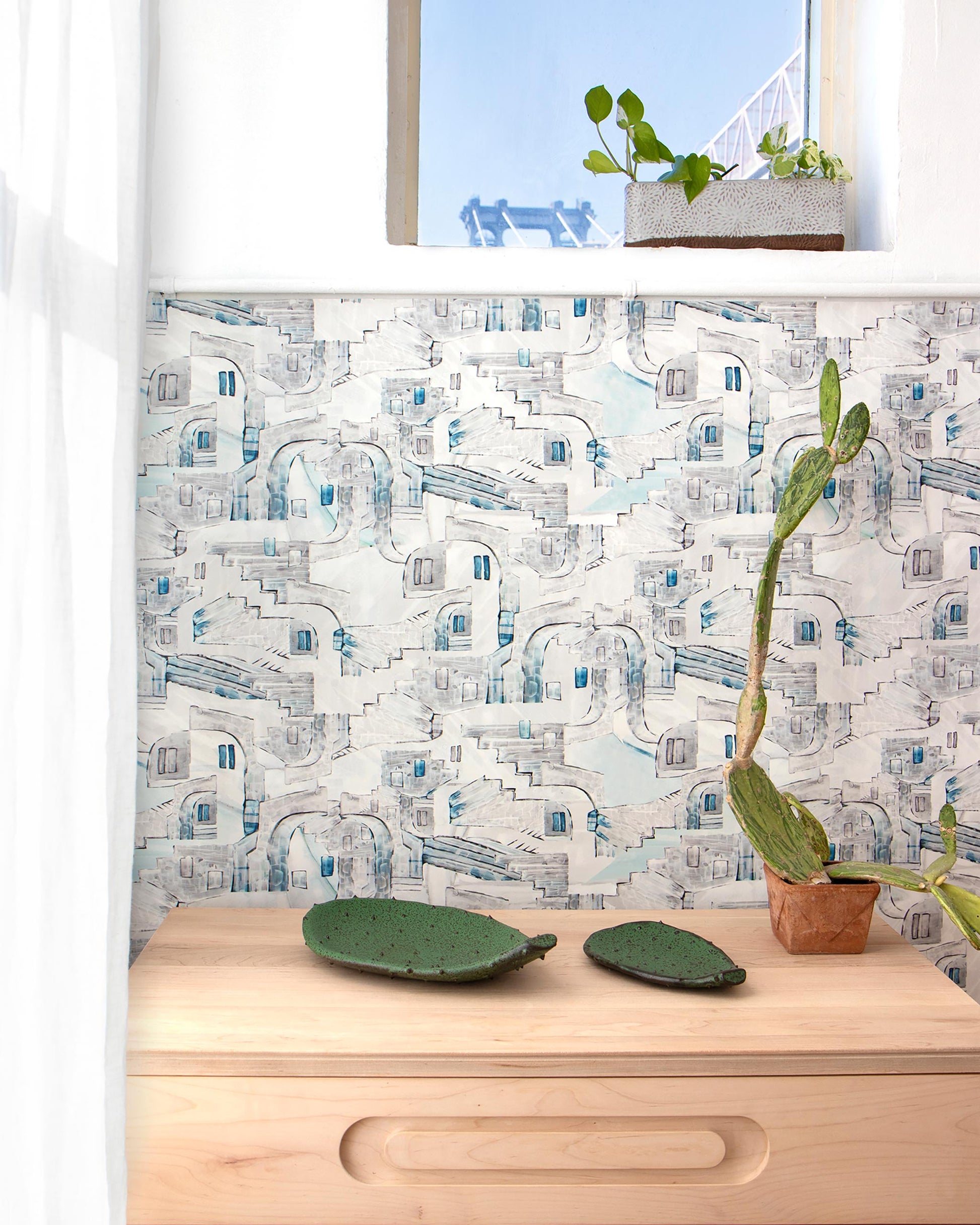 A wooden La Scala Wallpaper Notte with a plant on it next to a window