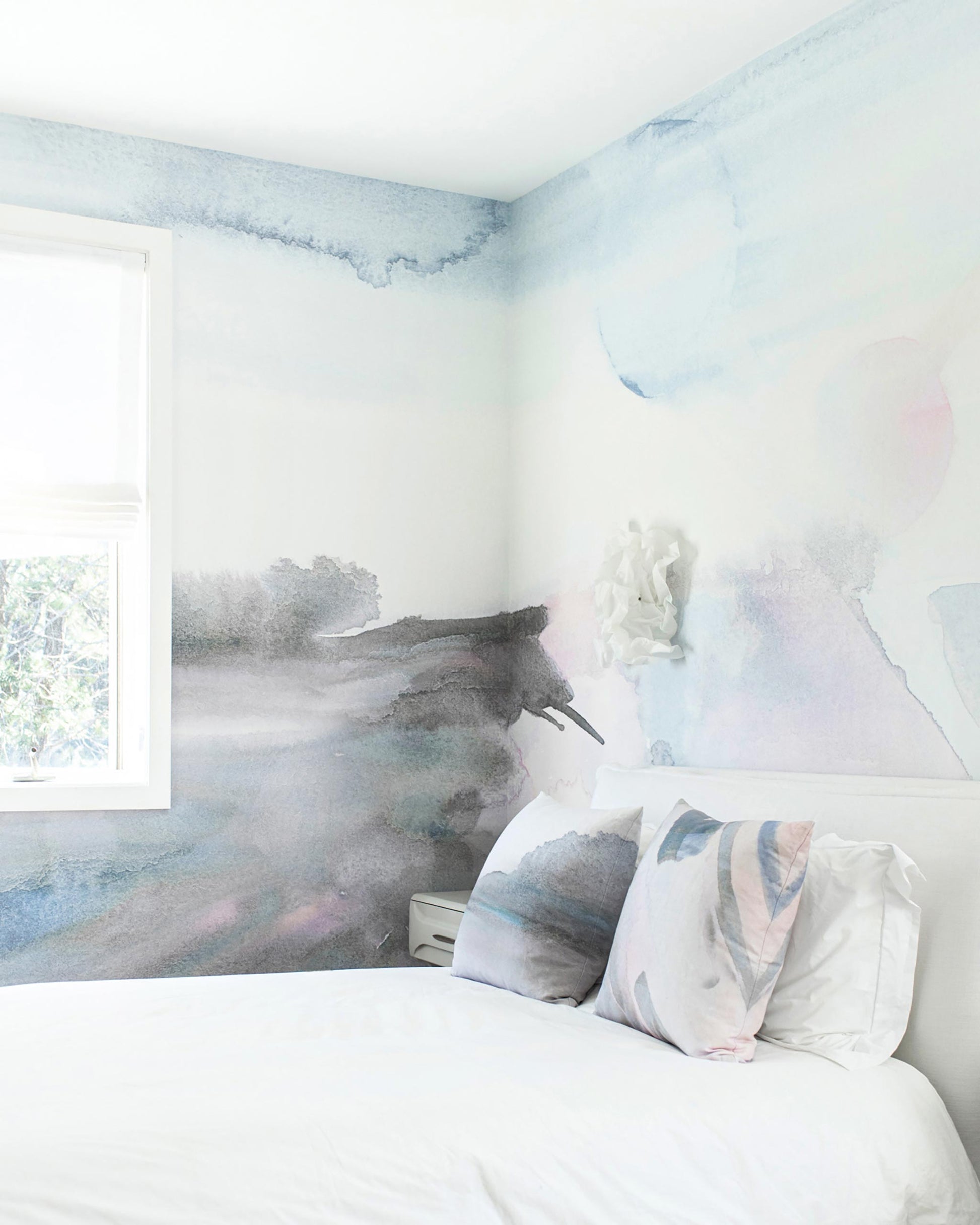 A bedroom with a white bed and a Lily's View Wallpaper Mural Dusk painted wall from Lily's View Collection