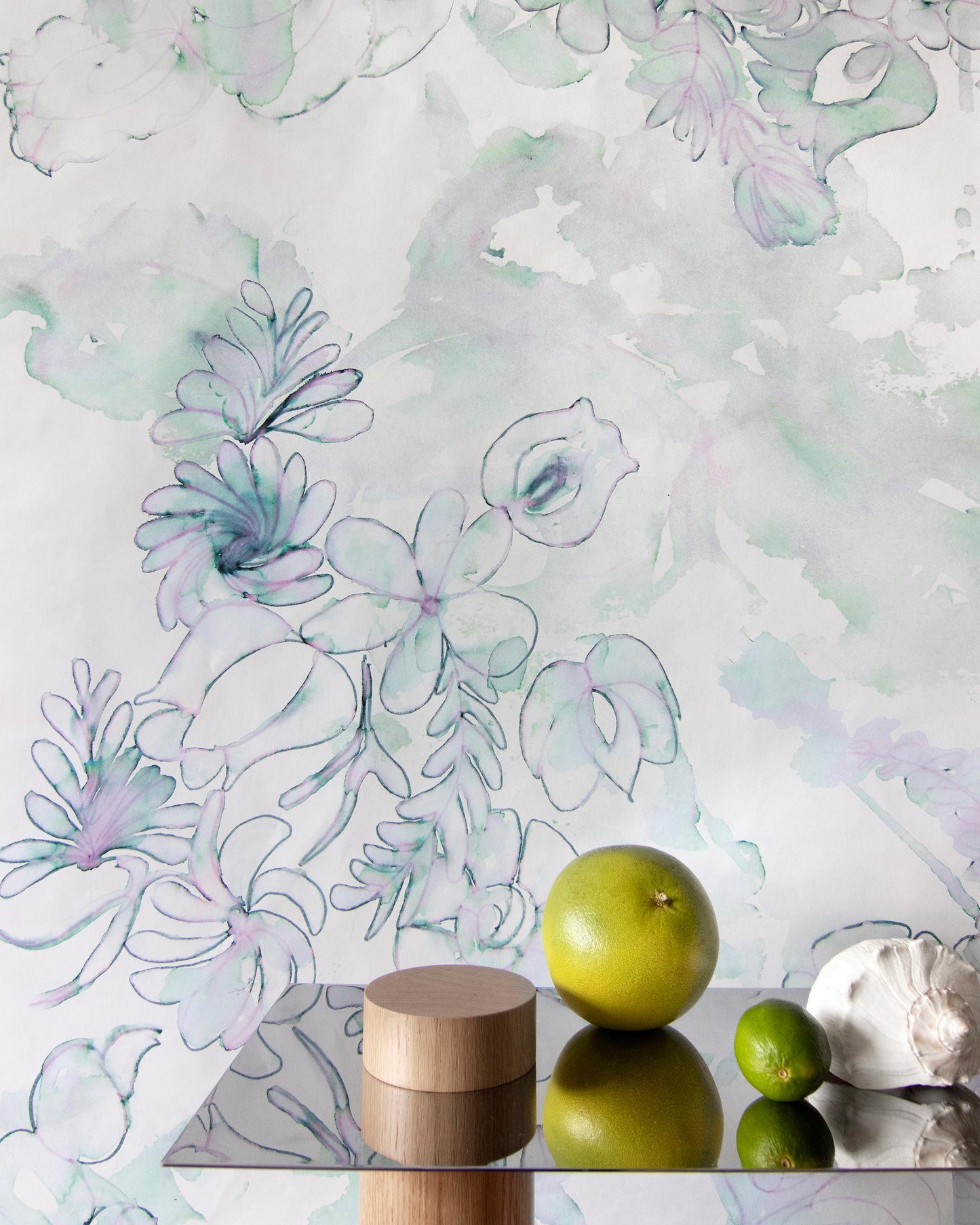 A green apple is sitting on a table in front of Belize Blooms Wallpaper