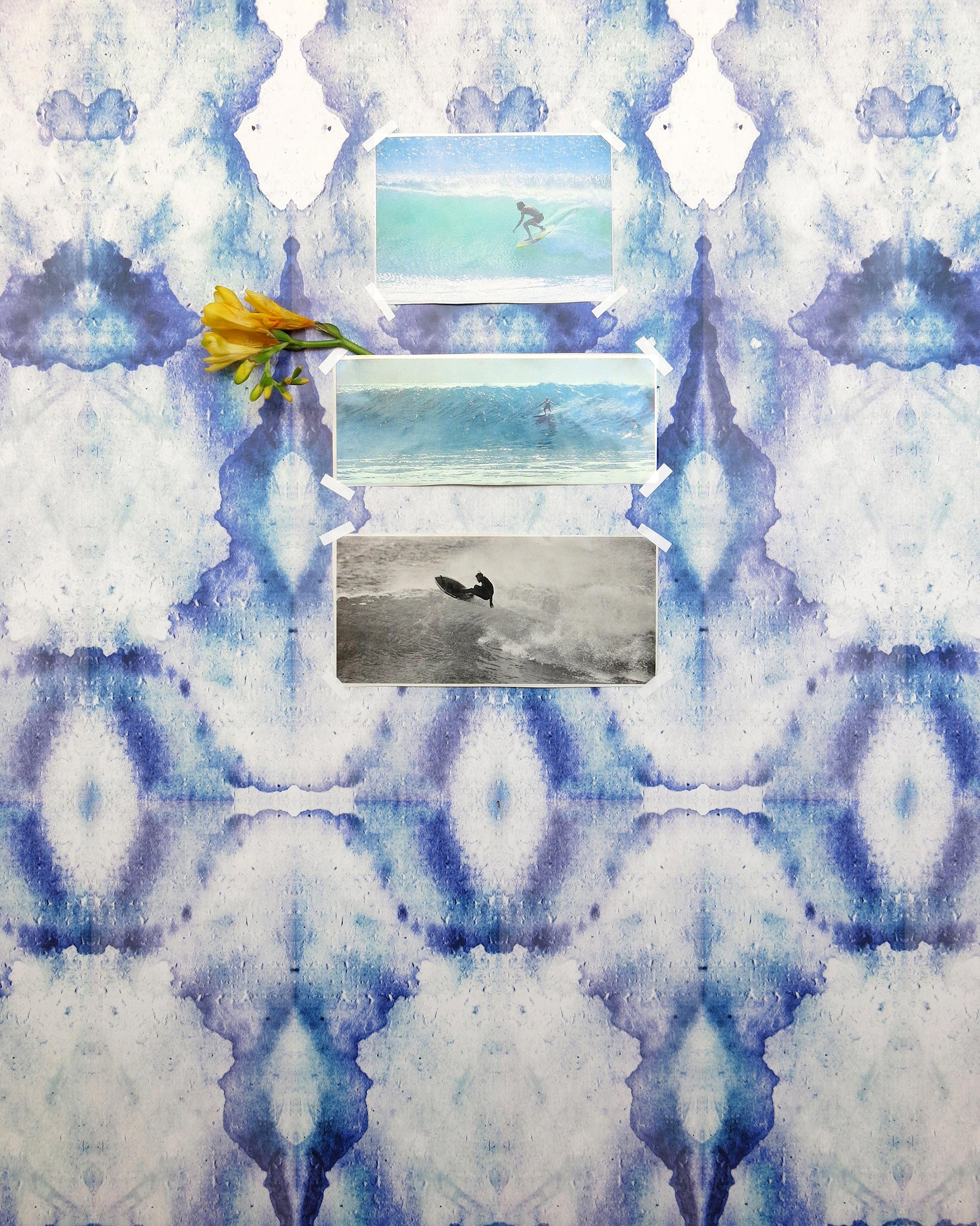 A blue and white photo of a surfboard on a wall decorated with luxury high-end Bungalow Wallpaper Royal watercolor designs