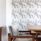 A wooden table and chairs in a room with Chess Wallpaper Grey on the wall