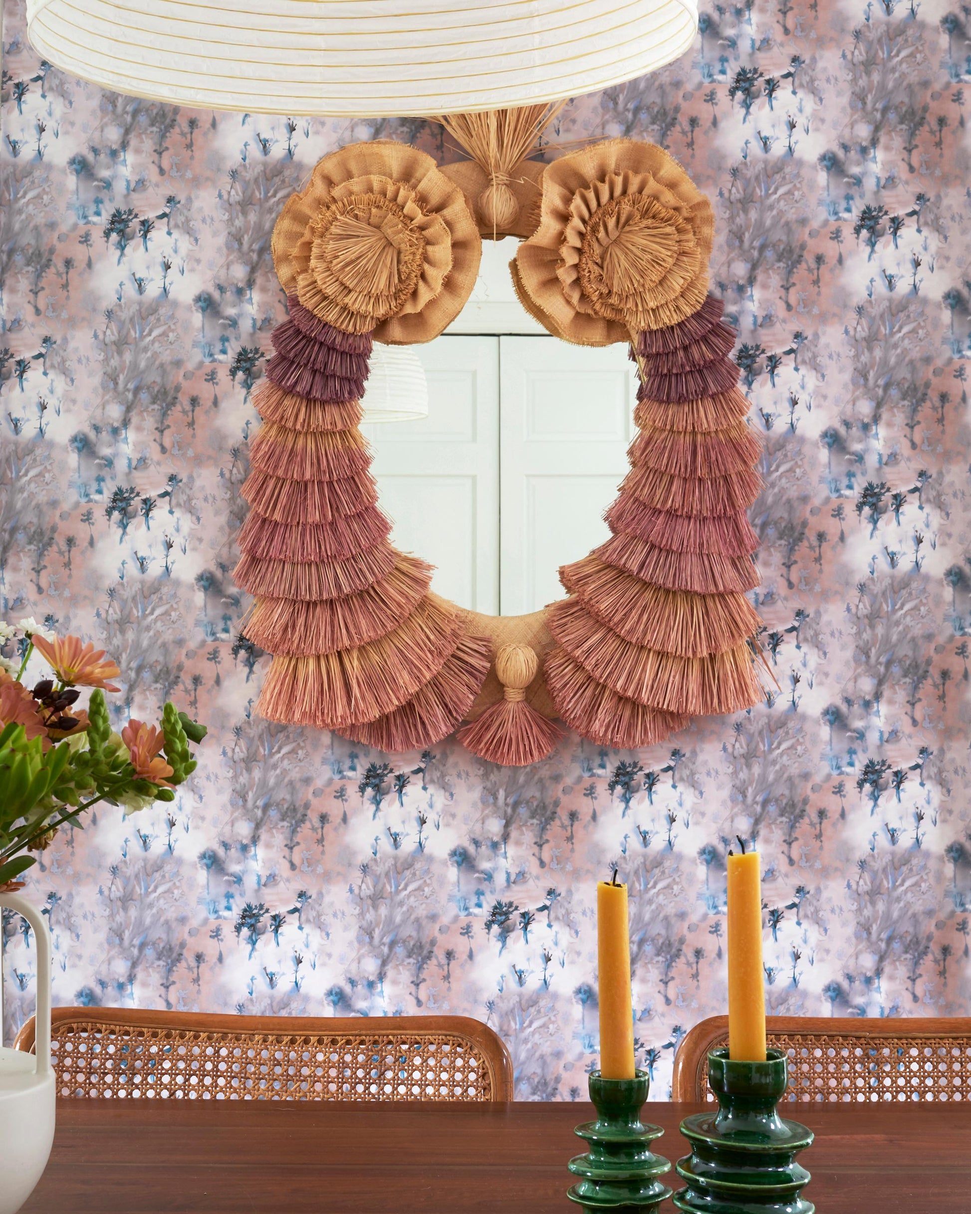 A dining room with a Emvasia Wallpaper Isthmus and a mirror