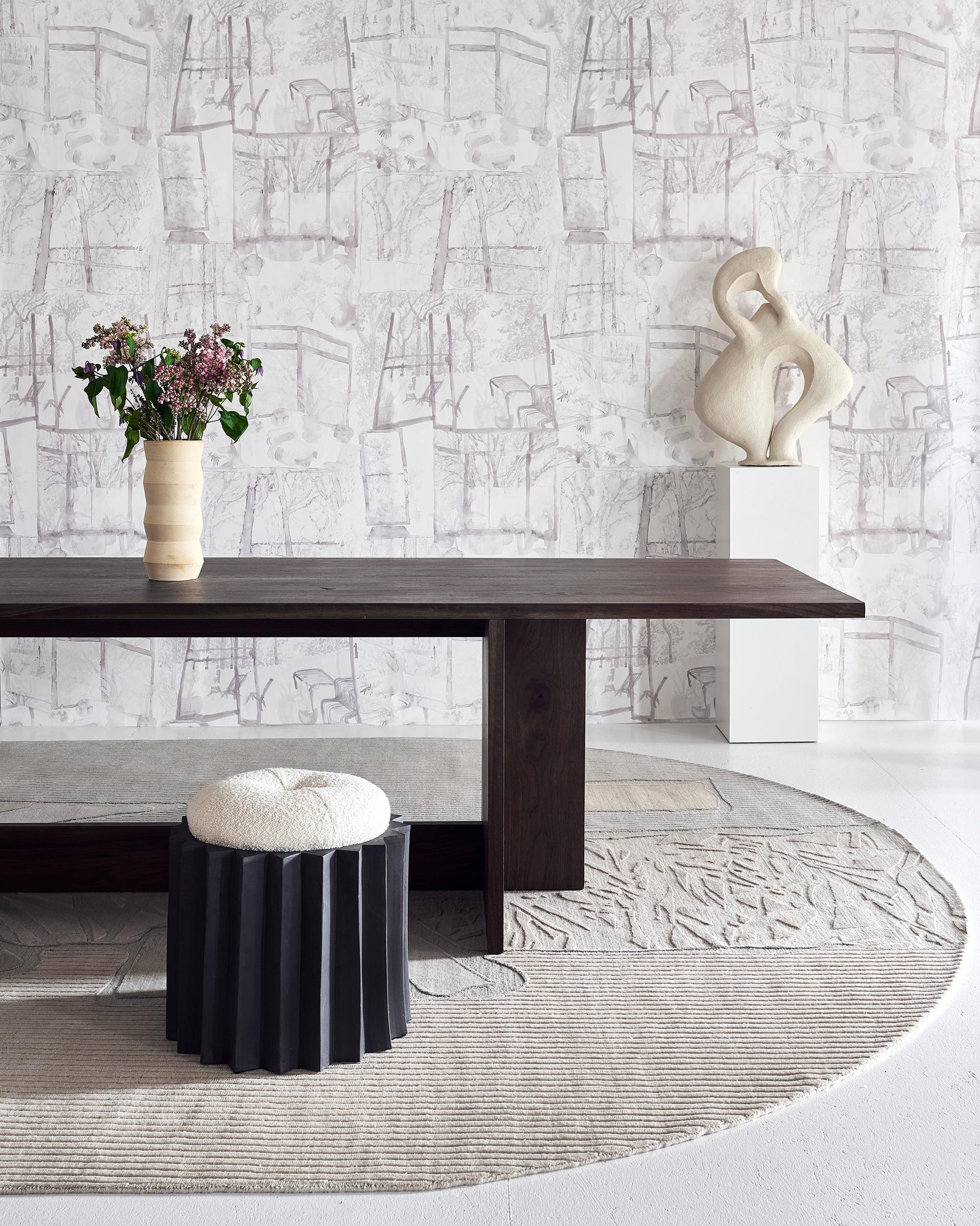 A dining room with Quotidiana Wallpaper Sand, neutral tones and verdant views