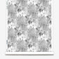 A black and white Emvasia Wallpaper Phyllite with microprint trees on it