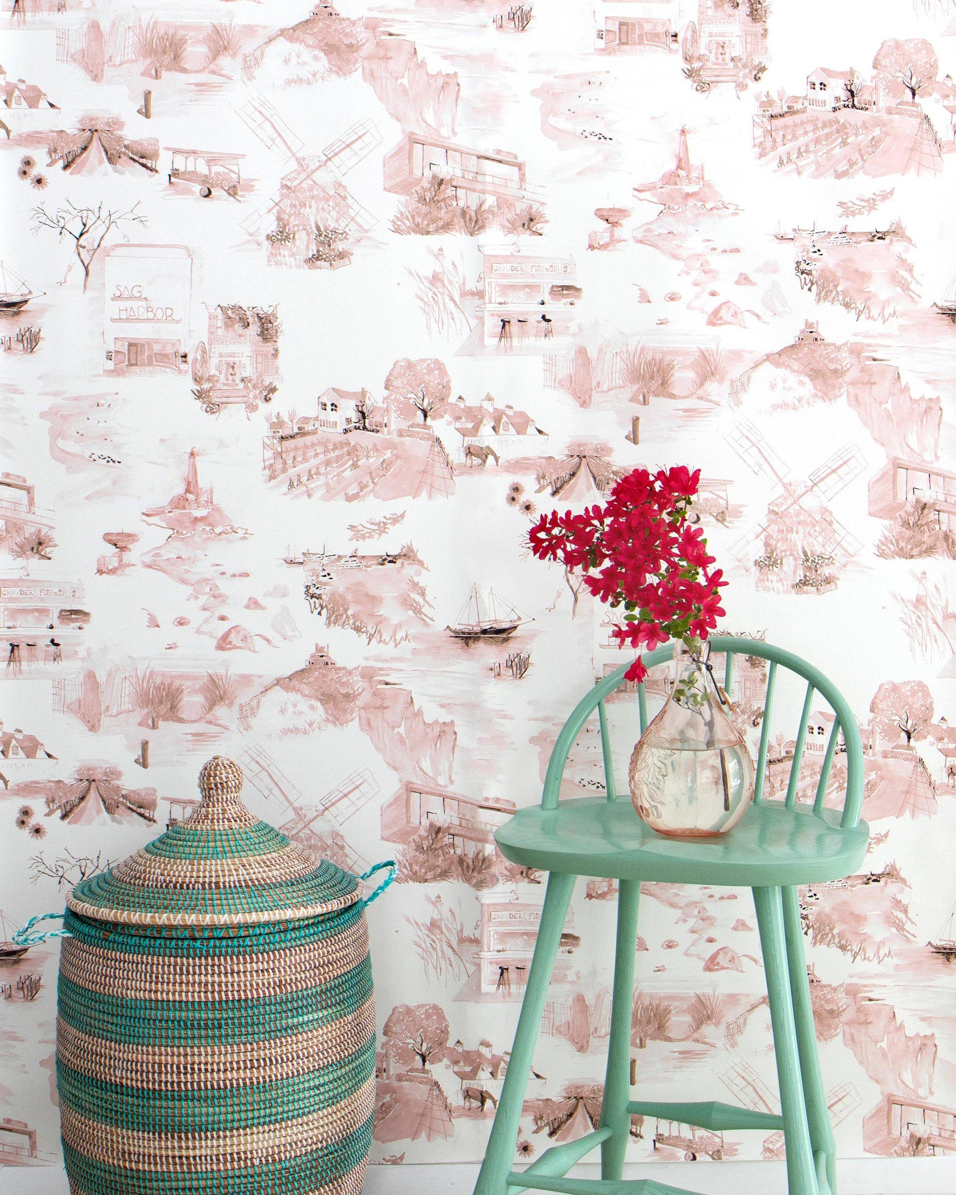 A pink Out East Wallpaper Shell with a fabric basket in front of it