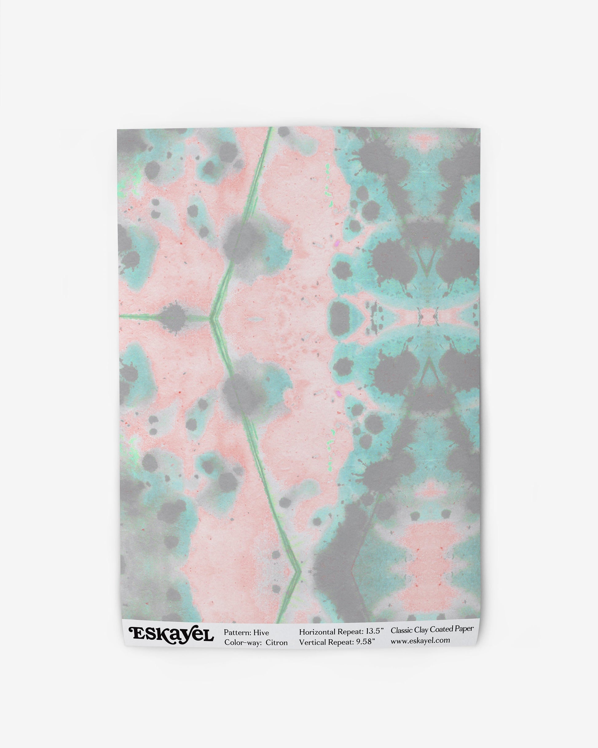 A pink, green, and blue Hive Wallpaper in the Citron colorway creates an abstract design by Eskayel