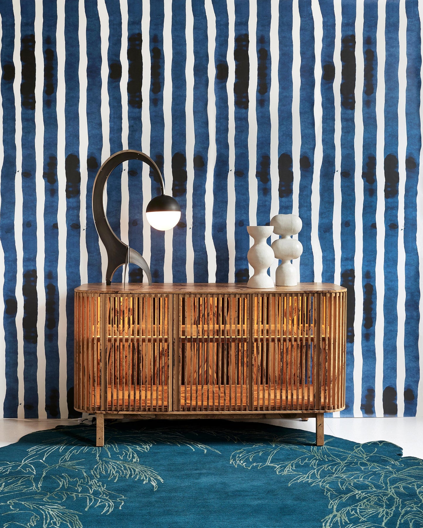A blue striped Bold Stripe Wallpaper||Azure in front of a blue dresser.