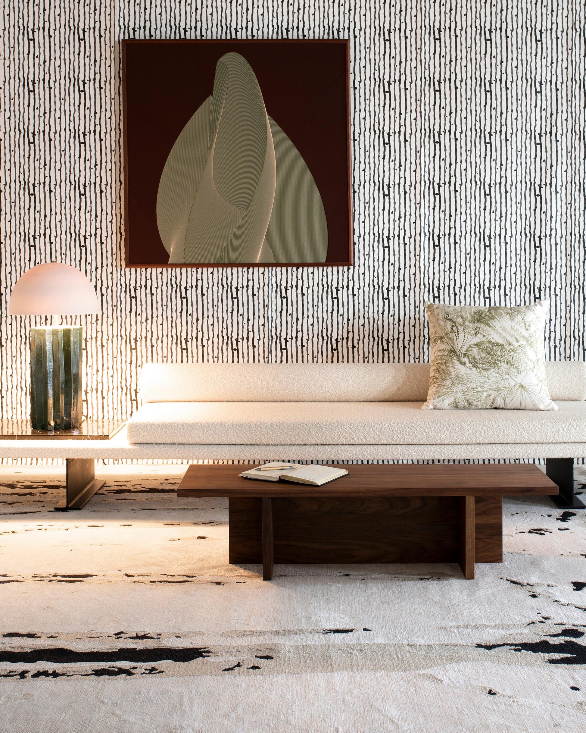 A living room with a couch and Drippy Stripe Wallpaper Slate table