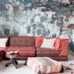 A living room with a colorful mural on the Kotoubia Wallpaper Mural Tesoro wall in Morocco