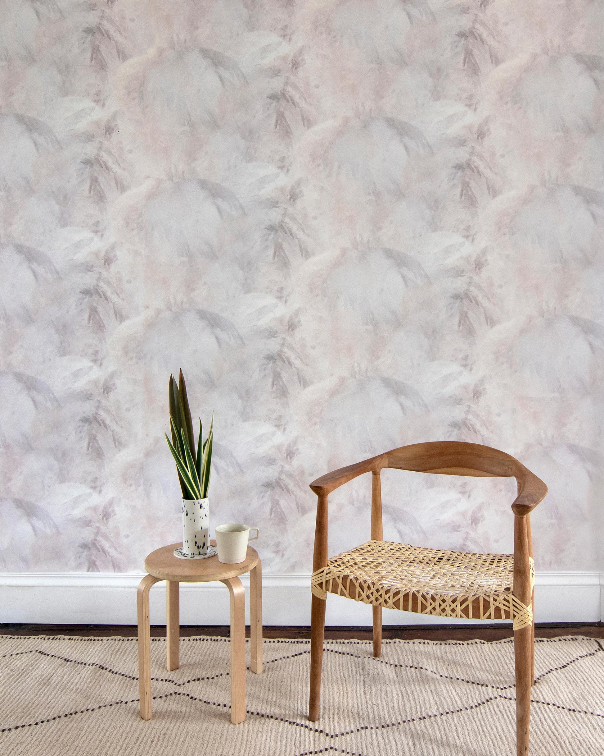 A room with a white chair and Palmeti Wallpaper Luminosa fabric pattern