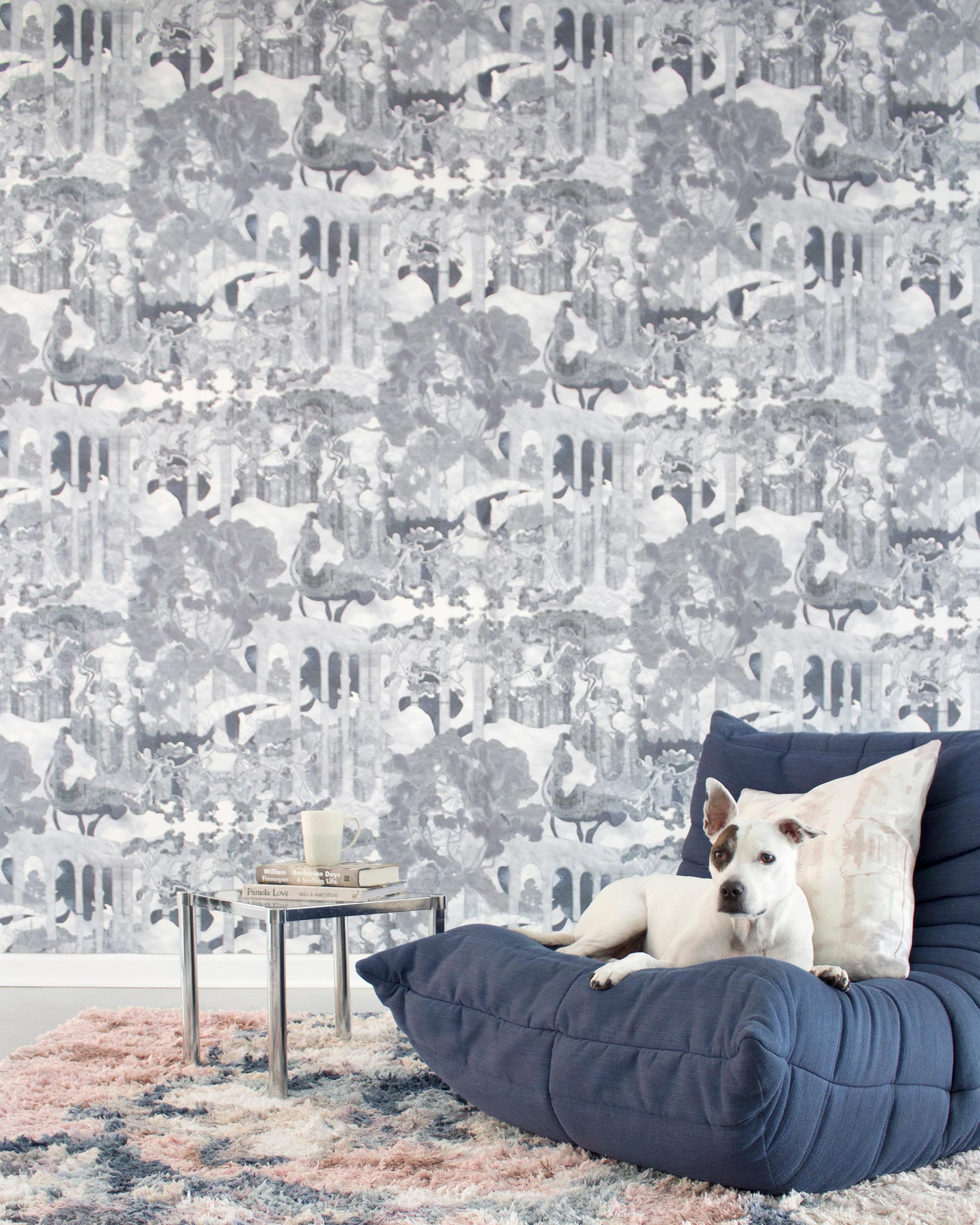 A dog is sitting on a blue bean bag in front of Presidio Wallpaper||Navy.