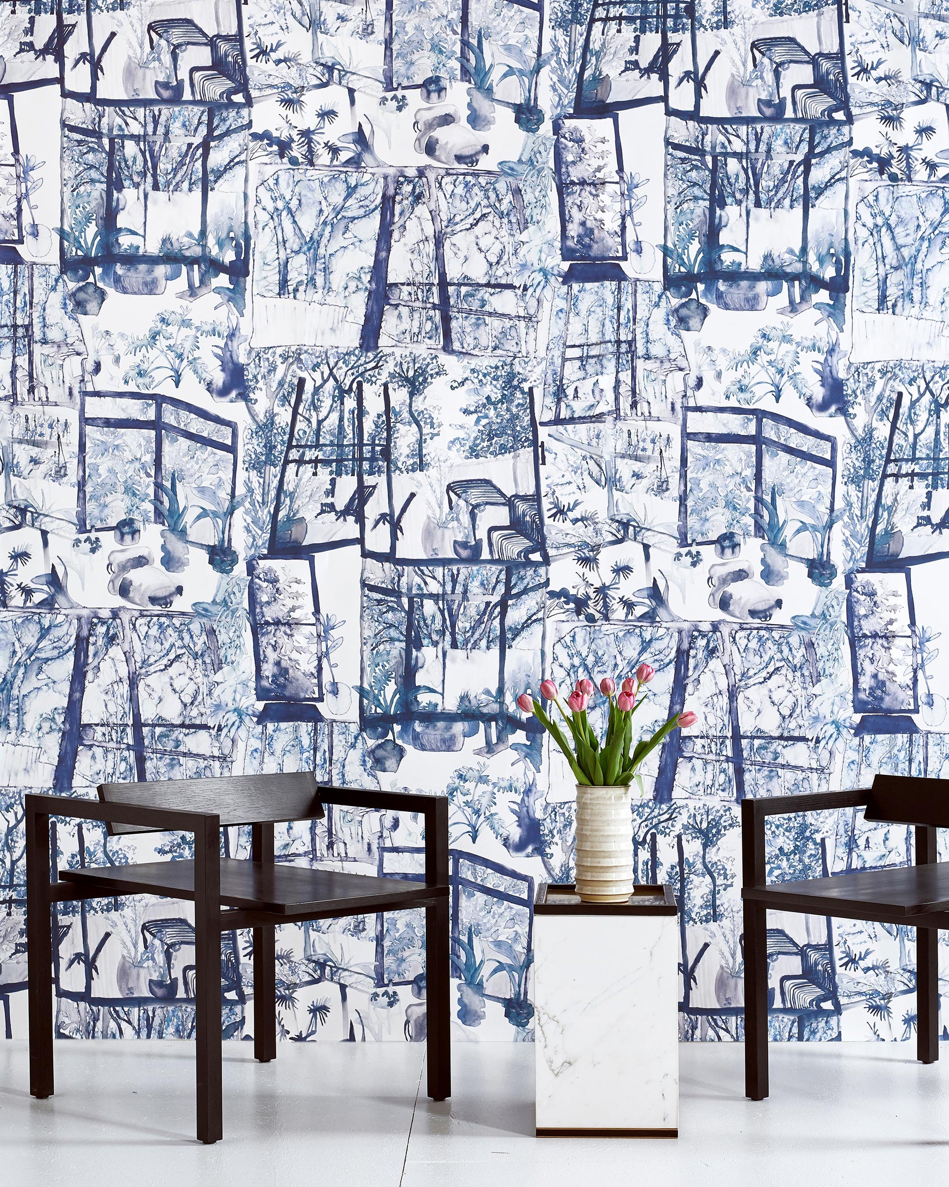 Two chairs in front of a high-end blue and white Quotidiana Wallpaper Midnight pattern
