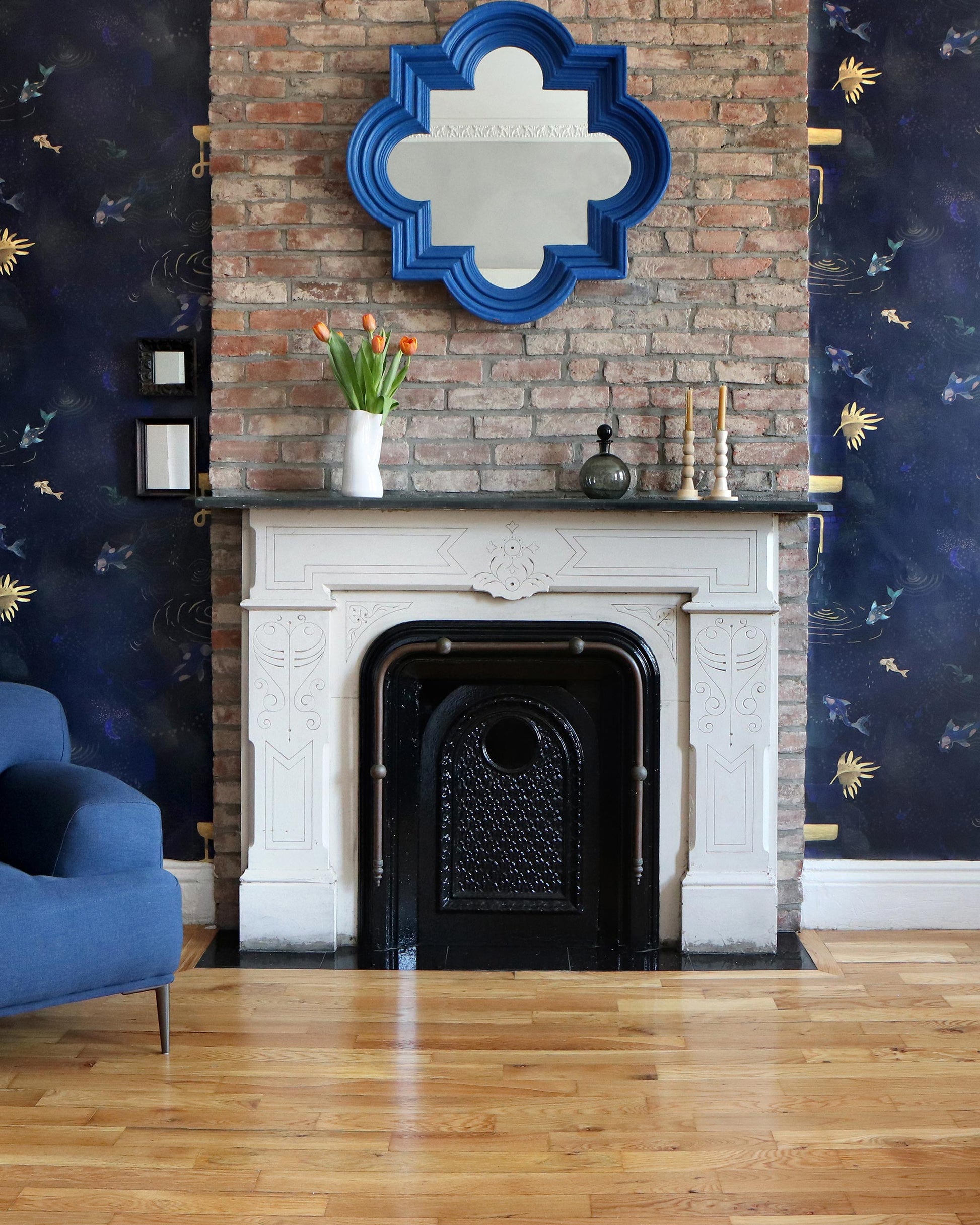 A blue Water Signs Wallpaper Indigo in a living room with a fireplace and high-end fabric