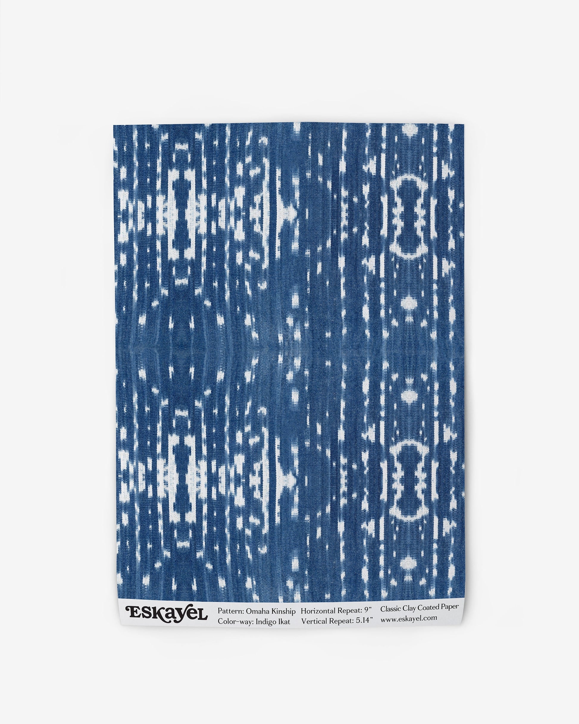 A blue and white Omaha Kinship Wallpaper Sample Indigo Ikat with an abstract pattern is available to order