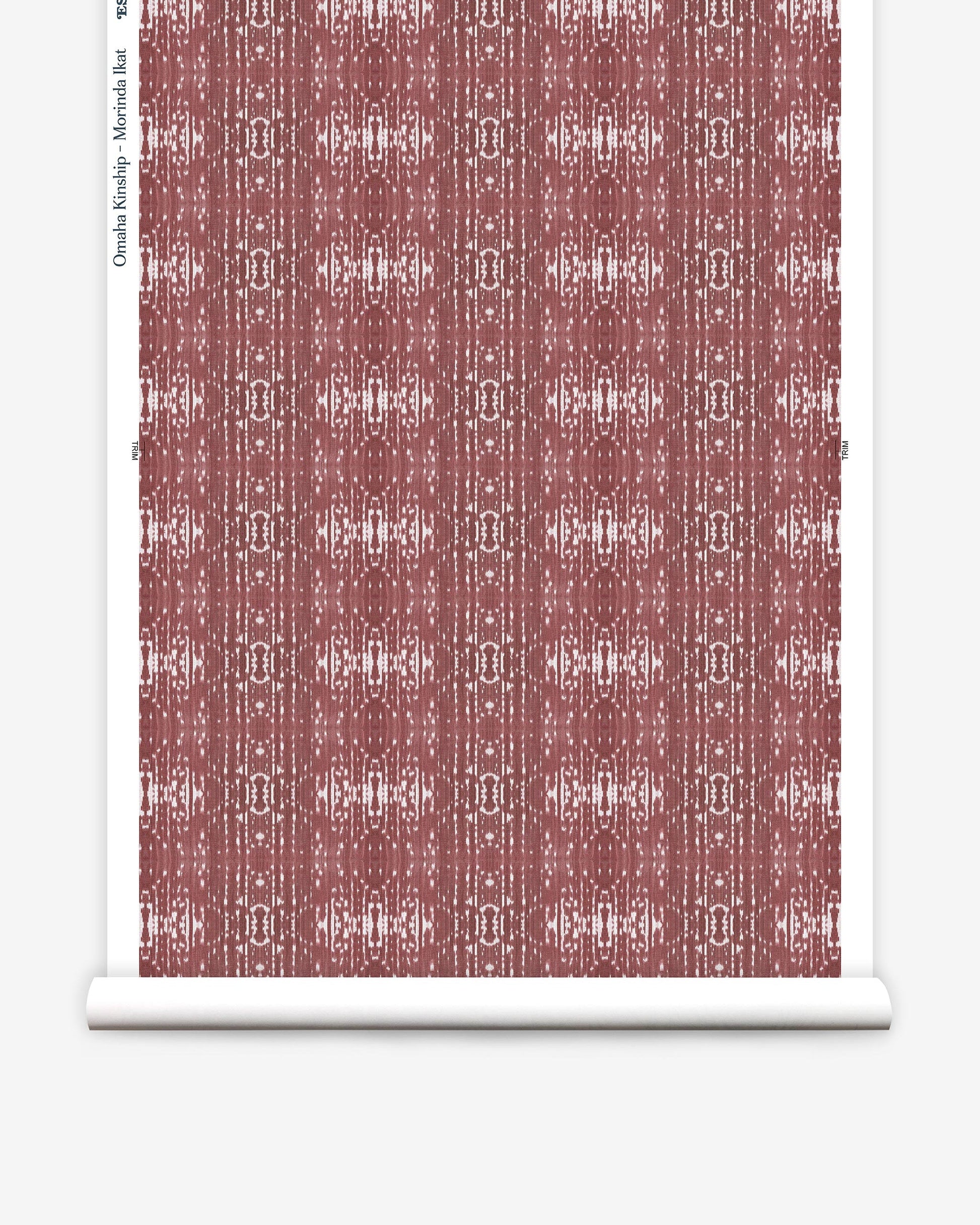 A paper with a red and white Omaha Kinship Wallpaper Morinda Ikat pattern on it