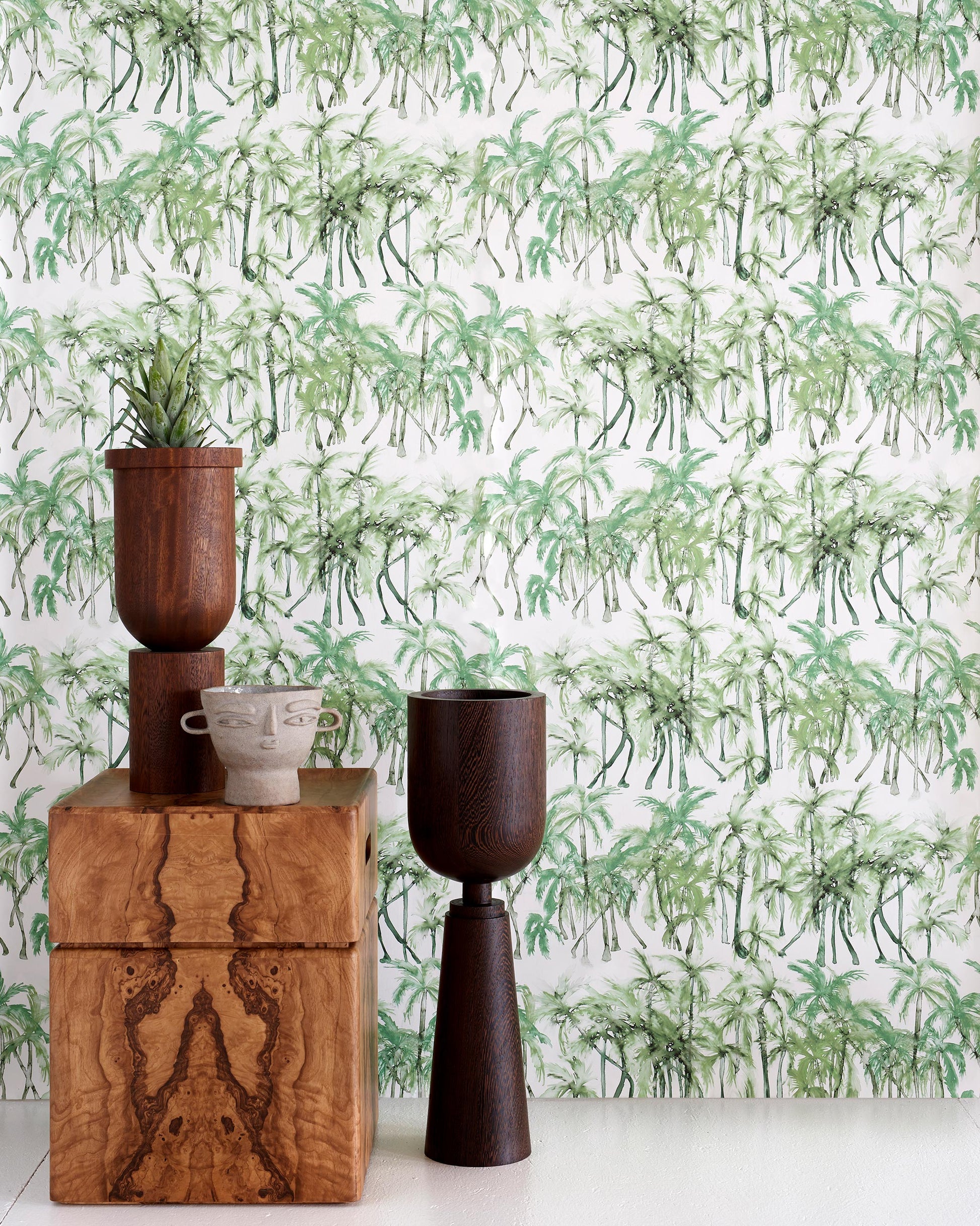 A Palm Dance Wallpaper Chloros pattern in front of a wooden table